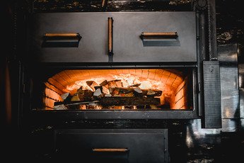 der Backraum wir mit Holz befeuert und somit auf die gewünschte Backtemperatur gebracht